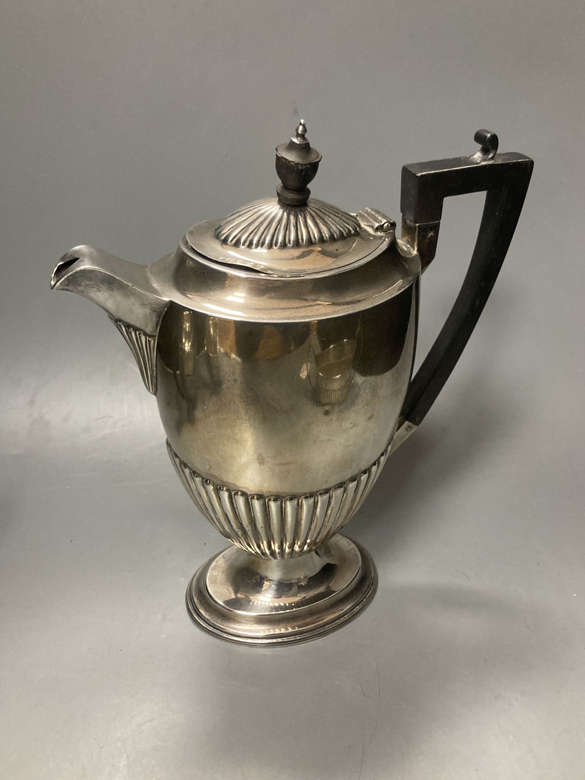 A late Victorian demi fluted silver three piece tea set, Mappin & Webb, Sheffield, 1897 & a matched hot water pot,